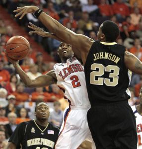 Demontez Stitt, left, shoots against Wake Forest's James Johnson during the first half of the basketball game in Clemson, S.C., Tuesday, Jan. 22, 2007. (AP Photo/Patrick Collard)