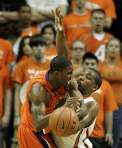Demontez Stitt loses control of the ball as he drives against Miami guard James Dews. (AP Photo/Wilfredo Lee)