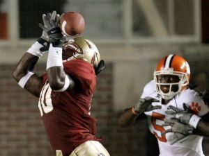 Florida State defensive back Geno Hayes, left, cannot make the interception of a Clemson pass intended for receiver Rendrick Taylor, right, during the second quarter of an NCAA football game, Saturday, Sept. 16, 2006, in Tallahassee, Fla.(AP Photo/Phil Coale)