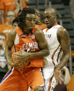 Raymond Sykes drives up against Miami center Anthony King during the first half. (AP Photo/Wilfredo Lee)