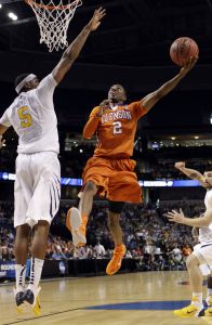 Clemson 's Demontez Stitt (2) goes for the basket as West Virginia's Kevin Jones (5) defends during the first half of an East regional second round NCAA tournament college basketball game in Tampa, Fla., Thursday, March 17, 2011. (AP Photo/Chris O'Meara)