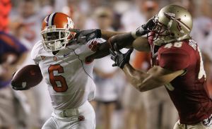 Clemson's Jacoby Ford, left, tries to fend off Florida State defender Anthony Houllis, right, during the first quarter of an NCAA football game, Saturday, Sept. 16, 2006, in Tallahasee, Fla.(AP Photo/Phil Coale)