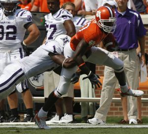 Clemson's Aaron Kelly, right, stretches for extra yards as he is tackled by Furman's William Middleton during a college football game in Clemson, S.C., Saturday, Sept. 15, 2007. (AP Photo/Patrick Collard)