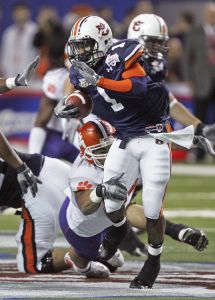 Auburn running back Brad Lester (1) breaks free from Clemson defensive end Phillip Merling during the first quarter of the Chick-fil-A Bowl football game Monday, Dec. 31, 2007, in Atlanta. (AP Photo/John Bazemore)