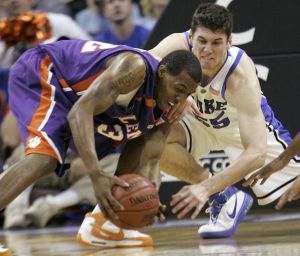 Sam Perry and Duke's Brian Zoubek chase a loose ball during the first half. (AP Photo/Gerry Broome)
