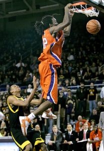 Raymond Sykes slams a dunk as East Carolina's John Fields looks on during the second half of a college basketball game in Greenville, N.C., Wednesday, Dec. 5, 2007. Clemson won 82-67. (AP Photo/Gerry Broome)