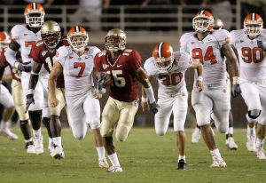 Florida State's Tony Carter, center, takes off with a blocked second-quarter field goal-attempt by Clemson during an NCAA football game, Saturday, Sept. 16, 2006, in Tallahassee, Fla. Carter returned the block for a touchdown. Clemson's Jad Dean (7) Cole Chason (30) Phillip Merling (94) and Zach Green(90), give chase.(AP Photo/Phil Coale)