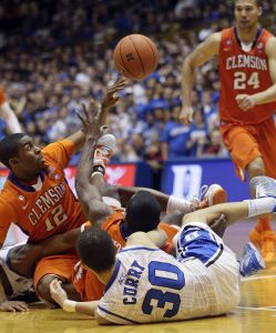 Duke's Seth Curry (30) and Clemson's Cory Stanton (12) and Andre Young grapple for possession during the second half an NCAA college basketball game in Durham, N.C., Wednesday, March 2, 2011. (AP Photo/Gerry Broome)