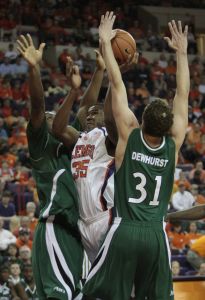 Clemson's Trevor Booker shoots against Charlotte's Lamont Mack, left, and Charles Dewhurst (31) during the first half.