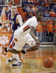 Clemson guard Demontez Stitt, front, draws a foul as he is tripped by Western Carolina forward Jake Robinson, back, during the second half of Clemson's 79-57 victory in an NCAA college basketball game Tuesday, Dec. 22, 2009, at Littlejohn Coliseum in Clemson, S.C. (AP Photo/Brett Flashnick)