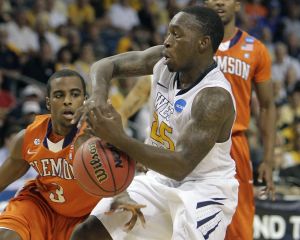Clemson's Zavier Anderson, left, knocks the ball from the hands of West Virginia's Darryl Bryant, right, during the first half of an East Regional second round NCAA tournament college basketball game in Tampa, Fla., Thursday, March 17, 2011. (AP Photo/John Raoux)