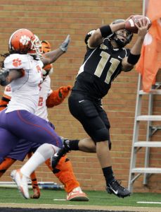 Wake Forest quarterback Riley Skinner (11) catches a touchdown pass as Clemson' Duane Coleman (3) defends during the second quarter of a college football game in Winston-Salem, N.C., Saturday, Oct. 7, 2006. (AP Photo/Chuck Burton)