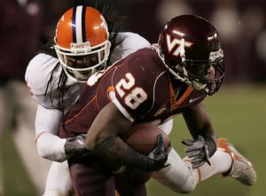 Virginia Tech running back Branden Ore (28) tries to break the tackle of Clemson defender Chris Clemons (22) during the Clemson Virginia Tech Atlantic Coast Conference college football game in Blacksburg, Va., Thursday, Oct. 26, 2006. (AP Photo/Steve Helber)