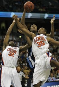 Villanova's Dante Cunningham pulls down a rebound behind Clemson defenders Sam Perry and Trevor Booker. (AP Photo/John Raoux)
