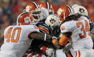 A swarming Clemson defense stops Auburn running back Michael Dyer (5) for a loss in the first half of their NCAA college football game at Jordan-Hare Stadium in Auburn, Ala., Saturday, Sept. 18, 2010. Defending for Clemson are Andre Branch (40) and Quandon Christian (34). (AP Photo/Dave Martin)