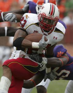 Maryland's Da'Rel Scott (23) gets stop for a loss of yardage by Clemson's Michael Hamlin (25) during the first half. (AP Photo/Mary Ann Chastain)