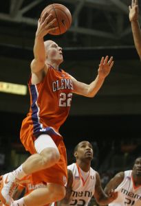 Clemson's Terrance Oglesby drives to the basket as Miami's James Dews, center, looks on during the second half. (AP Photo/Jeffrey M. Boan)