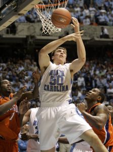 North Carolina's Tyler Hansbrough (50) pulls down a rebound over Clemson's K.C. Rivers, left, and Trevor Booker during the second half of a college basketball game in Chapel Hill, N.C., Sunday, Feb. 10, 2008. North Carolina won 103-93 in double overtime. (AP Photo/Gerry Broome)