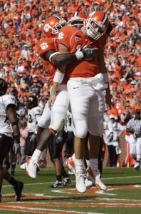 James Davis, left, Rendrick Taylor, center, and Cullen Harper, (10), right, celebrate after Harper scored a seven-yard touchdown in the first quarter. (AP Photo/Patrick Collard)