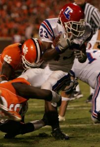 Louisiana Tech's Patrick Jackson gets stopped for a loss of yardage by Clemson's Phillip Merling(94) bottom and Nick Watson(32) in the first half. (AP Photo/MaryAnn Chastain)