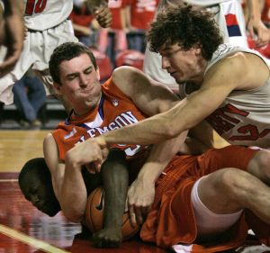 Clemson center Karolis Petrukonis, top left, tries to control a rebound as Liberty guard Jeremy Anderson, right, closes in during the second half of a college basketball game at the Vines Center in Lynchburg, Va., Tuesday, Nov. 17, 2009. Clemson won the game 79-39. Player at bottom left is unidentified. (AP Photo/Steve Helber)