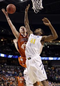 Clemson guard Tanner Smith (5) attempts a basket as West Virginia forward John Flowers (41) defends during the first half of an East regional second round NCAA tournament college basketball game in Tampa, Fla., Thursday, March 17, 2011. (AP Photo/Chris O'Meara)
