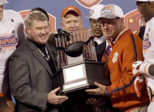 ACC Commissioner John Swofford presents the 2011 ACC Championship trophy to Head Coach Dabo Swinney.
