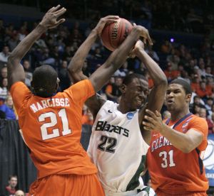 UAB forward Cameron Moore (22) is trapped by Clemson's Bryan Narcisse (21) and Devin Booker (31) in the first half of a first-round NCAA college basketball tournament game Tuesday, March 15, 2011, in Dayton, Ohio. (AP Photo/Skip Peterson)