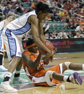 North Carolina's Iman McFarland reaches over D'Lesha Lloyd during the first half. (AP Photo/Chuck Burton)