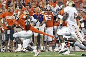 Clemson's James Davis (1) runs in for the touchdown against Florida State's Myron Rolle (3) as he tries to hold onto his jersey during the first quarter (AP Photo/Mary Ann Chastain)