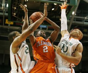 Clemson's Demontez Stitt, center, drives to the basket as Miami's Cyrus McGowan, left, and Jimmy Graham defend during first half of an NCAA college basketball game in Miami, Sunday, Dec. 21, 2008. (AP Photo/Jeffrey M. Boan)