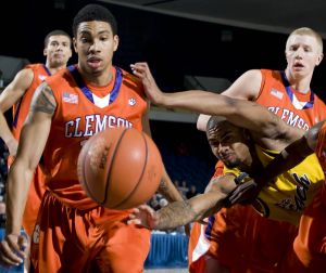 Long Beach State forward Eugene Phelps, front right, dives for a loose ball as Clemson forward David Potter, front left, and guard Tanner Smith, back right, look on during the first half of an NCAA college basketball game in the 76 Classic in Anaheim, Calif., Friday, Nov. 27, 2009. (AP Photo/Chris Carlson)