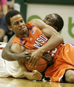 Cliff Hammonds battles for a loose ball with Miami forward Dwayne Collins during the second half. (AP Photo/Wilfredo Lee)