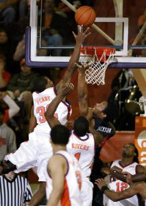 Clemson's Sam Perry (32) goes high for the ball as Georgia's Albert Jackson attempts to defend during the first half of a basketball game Thursday evening, Dec. 28, 2006, at Littlejohn Coliseum in Clemson, S.C. (AP Photo/Willis Glassgow)