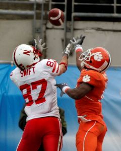Nebraska wide receiver Nate Swift, left, catches a third-quarter touchdown pass despite the defensive effort of Clemson cornerback Crezdon Butler during the Gator Bowl. (AP Photo/Phil Coale)