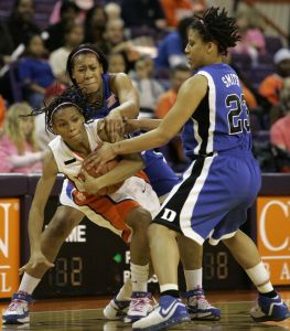 Clemson's Christy Brown center, tries to hold onto the ball as she is double teamed by Duke's Joy Cheek and Wanisha Smith, right, during the first half of their basketball game Wednesday, Feb. 13, 2008, in Clemson, S.C. (AP Photo/Mary Ann Chastain)