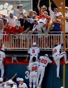 team climb fence postgame celebrate