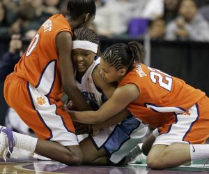 North Carolina's Cetera DeGraffenreid tries to keep the ball from Sthefany Thomas, right, and Kirstyn Wright, left, during the second half. (AP Photo/Chuck Burton)