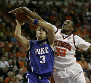 Duke's Greg Paulus (3) gets fouled by Clemson's Sam Perry (32) as he drives for the basket during the first half of their basketball game Thursday, Feb. 22, 2007, at Littlejohn Coliseum in Clemson, S.C. (AP Photo/Mary Ann Chastain)