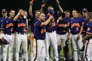 team celebrate on field with jack leggett