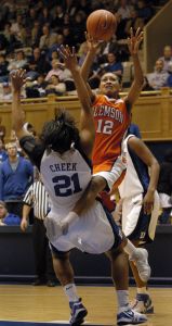 Clemson's Tasha Taylor (12) pushes off of Joy Cheek (21) as she drives toward the basket in the second half of a basketball game in Durham, N.C., on Monday, Feb. 5, 2007. Duke won 105-53 over Clemson. (AP Photo/Sara D. Davis)