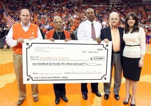 oliver and vicky purnell present check to coaches vs. cancer