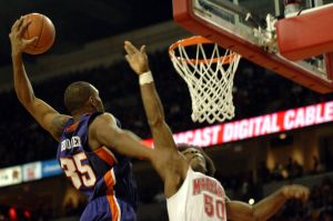 Trevor Booker dunks over Bambale Osby (Photo by Zach Hanby)