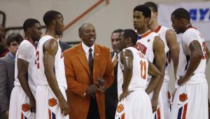 Head Coach Oliver Purnell and team huddle during timeout