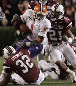 Clemson's James Davis (1) tries to stay on his feet as South Carolina's Darian Stewart (32) and Emanuel Cook try to stop him during the first quarter of their football game Saturday, Nov. 24, 2007, at Williams Brice Stadium in Columbia, S.C. (AP Photo/Mary Ann Chastain)