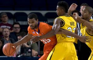 Clemson forward Trevor Booker, left, drives around Long Beach State guard Casper Ware during the first half of an NCAA college basketball game in the 76 Classic in Anaheim, Calif., Friday, Nov. 27, 2009. (AP Photo/Chris Carlson)