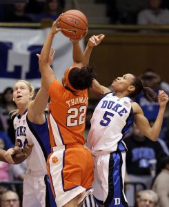 Duke's Kathleen Scheer, left, and Jasmine Thomas defend as Clemson's Sthefany Thomas shoots in the first half of the game. (AP Photo/Gerry Broome)