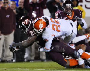 Virginia Tech running back Branden Ore (28) scores a touchdown as Clemson defender Chris Clemons (22) tries to make the stop during the Clemson-Virginia Tech Atlantic Coast conference college football game in Blacksburg, Va., Thursday Oct. 26, 2006. Techwon the game, 24-7. (AP Photo/Don Petersen)