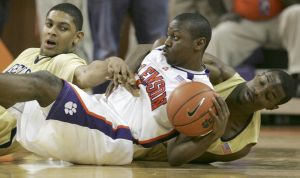 Andre Young keeps control of the ball as Lance Storrs and Gani Lawal reach for it during the first half.