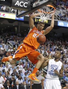 Clemson's Milton Jennings, left, dunks as North Carolina's Justin Knox, right, looks on during the first half of an NCAA college basketball game at the Atlantic Coast Conference tournament in Greensboro, N.C., Saturday, March 12, 2011. (AP Photo/Bob Leverone)